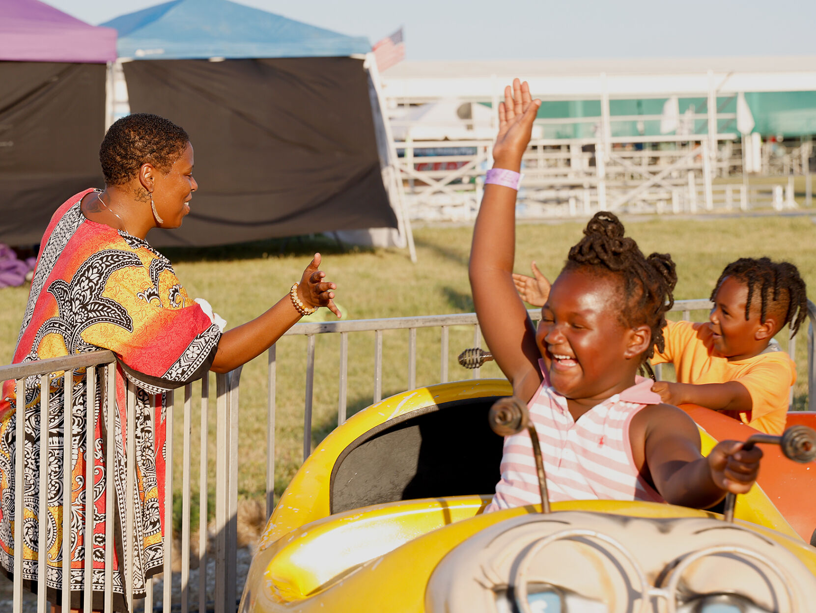 Corina McClee, left, high-fives Maya Bowden and Chris Bowden